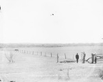 The Lyden oil pool, south from the W.W. Cunningham Farm; three men stand near an open field, one man points toward oil derricks past a stand of trees by Basil Clemons 1887-1964