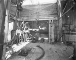 Men working in the oil fields inside wooden structure near Breckenridge, Texas by Basil Clemons 1887-1964