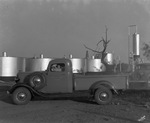 Oil tanks in background; sign on truck reads "Werner Tank Co., Breckenridge, Texas" by Basil Clemons 1887-1964