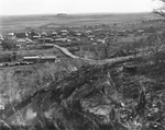 Aerial view of small settlement of wooden buildings and road near cleared land, oil field near Breckenridge, Texas by Basil Clemons 1887-1964