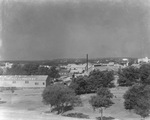 Settlement of buildings and houses among trees with oil wells in far distance, Breckenridge, Texas by Basil Clemons 1887-1964