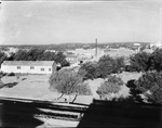 Businesses in Breckenridge, Texas, including The Continental Supply Company, Fishing Tools, and Brown Tool Company with oil derricks in the background by Basil Clemons 1887-1964