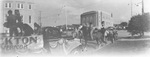 People on horseback and trucks with banners preparing for a parade through downtown Breckenridge, Texas by Basil Clemons 1887-1964