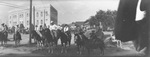 People on horseback preparing for a parade through downtown Breckenridge, Texas by Basil Clemons 1887-1964