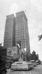 Parade with floats in downtown Fort Worth, Texas with the W. T. Waggoner building in the background by Basil Clemons 1887-1964