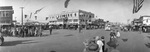 A panoramic photograph of a parade through downtown Breckenridge, Texas by Basil Clemons 1887-1964