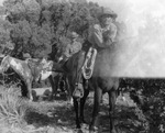 Two unidentified men on horseback with a third saddled horse on an unidentified ranch in Stephens County, Texas by Basil Clemons 1887-1964