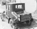 Automobile with a wooden tool box on back, parked next to house, Breckenridge, Texas by Basil Clemons 1887-1964