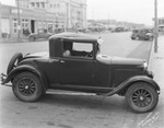 Automobile parked by curb on street of Breckenridge, Texas by Basil Clemons 1887-1964