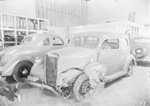 Three automobiles on a service lot, one with a crumpled fender, Breckenridge, Texas by Basil Clemons 1887-1964