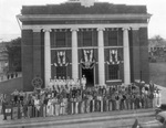 Boy Scouts and Sea Scouts holding flags on the steps of the Breckenridge, Texas Municipal building by Basil Clemons 1887-1964