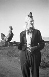 Circus clown holds a rooster on a perch, Breckenridge, Texas by Basil Clemons 1887-1964