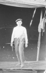 Circus performer with a small monkey on a leash at his hip, Breckenridge, Texas by Basil Clemons 1887-1964