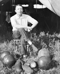 Circus performer with his equipment of balls and gloves in front of him, Breckenridge, Texas by Basil Clemons 1887-1964