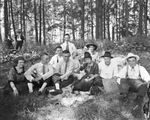 Group of circus performers enjoy a picnic setting under the trees, Breckenridge, Texas. by Basil Clemons 1887-1964