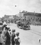 Circus parade along a downtown street with spectators along the edges, Breckenridge, Texas by Basil Clemons 1887-1964