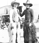 Two rodeo performers wearing fancy chaps, Breckenridge, Texas by Basil Clemons 1887-1964