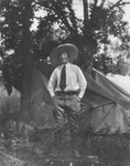 A cowgirl standing on a suitcase by Basil Clemons