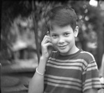 Young boy posing in a striped shirt by Basil Clemons 1887-1964