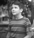 Young boy posing in a striped shirt by Basil Clemons 1887-1964