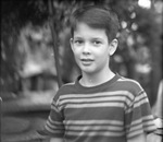 Young boy posing in a striped shirt by Basil Clemons 1887-1964