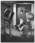 Woman in studio with photographer, 1949 by Bill Wood Photo Company