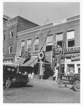 New sign being put on Bill Wood Photo Company storefront, 1950 by Bill Wood Photo Company