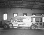 Jack Perry and the Light Crust Doughboys truck parked in warehouse by Bill Wood Photo Company