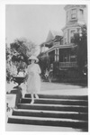 Ellen Morland Bowie on steps in front of house