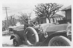 Barney Holland in an automobile