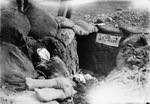 World War I battle trench with sign over entrance to underground tunnel that reads "Suicide Alley"