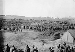 Field full of hundreds of World War I soldiers watching an outdoor boxing match