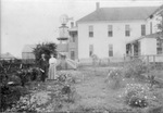 Carlisle Military Academy superintendent's home with Colonel James M. Carlisle and his wife Julia Carlisle standing near their garden