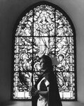 Nursing student in front of a stained glass window