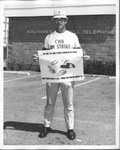 Communications Workers of America striker Charlie Lawrance with poster