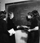 Dora Nichols with students at blackboard, Arlington, Texas