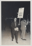 Man Holding Sign & Pamphlet