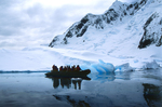 Group on a boat along the coastline in Antarctica.