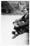 George Lambert in military uniform sitting in the sand