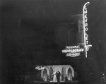 A night shot of neon lights of Hooker Vandergriff Chevrolet dealership