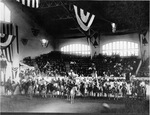 Comanche Chief Quanah Parker on a white horse with Burk Burnett on the extreme left at the Livestock Exhibition and Fat Stock Show, Fort Worth's Northside Coliseum