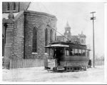 Electric street car in snow by Saint Patrick's Catholic Church, 1206 Throckmorton Street, downtown Fort Worth, Texas