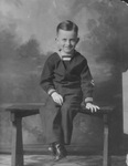 Jack D. White in little boy's sailor uniform, formal portrait