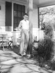 Jack D. White standing on the porch of his home at age 12