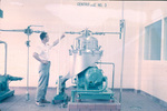 Man adjusting Centrifuge No. 3, Carling Brewery