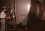 Man adjusting lever on 1st and 2nd Stage Fermenting Tank, Carling Brewery