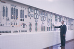 Man adjusting dials on wall, Carling Brewery