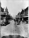 Electric street car next to horse drawn buggy in downtown Fort Worth, Texas