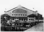 Fort Worth's North Side Coliseum with horses and wagons on the street in front of the building