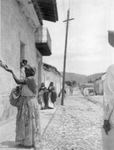 Woman in long skirt and shawl receives money